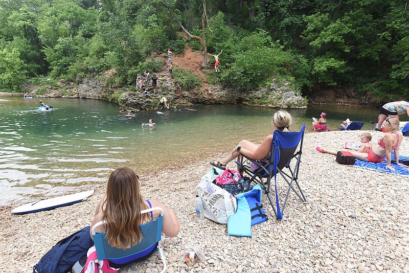 Come on in, the water's fine at the McKissic Creek swimming hole in Bentonville. Swimming holes along the Ozark's streams offer cool relief from the summer heat, along with gravel beaches perfect for a picnic or just relaxing. 
(NWA Democrat-Gazette/Flip Putthoff)