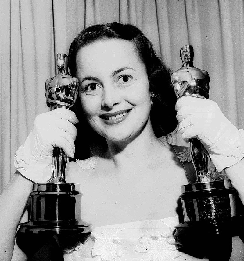 Actress Olivia de Havilland holds her Oscar statues in this March 24, 1950, file photo. De Havilland won for her performance that year in “The Heiress,” and in “To Each His Own” in 1946.

(AP file photo)