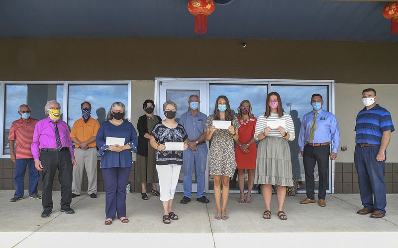 Members of The Greater Hot Springs Kiwanis Club, back, honored school personnel who go "above and beyond" on Tuesday, July 21, at Hibachi Sushi Buffet, 4334 Central Ave. Honorees included front, from left, Angela Arnaud, of Cutter Morning Star, Jan Sligh, of Park Magnet, Kaitlyn Hill, of Mountain Pine Elementary School, and Kaitlin Boles, of Lakeside High School. - Photo by Grace Brown of The Sentinel-Record