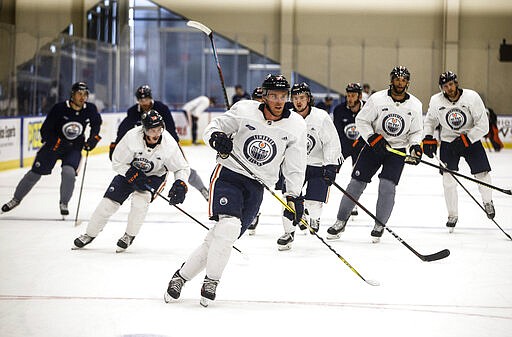 Edmonton Oilers' Connor McDavid (97) leads a skate during NHL hockey practice, Thursday, July 23, 2020, in Edmonton, Alberta. (Jason Franson/The Canadian Press via AP)