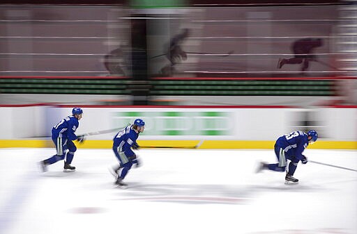 Vancouver Canucks' Troy Stecher, from left to right, Adam Gaudette and Bo Horvat skate during the NHL hockey team's training camp in Vancouver, on Wednesday, July 22, 2020. (Darryl Dyck/The Canadian Press via AP)