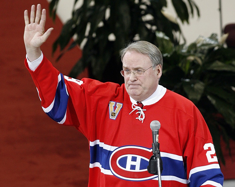 FILE - In this Jan. 29, 2007 file photo, Former Montreal Canadiens goaltender Ken Dryden waves to the crowd at the Bell Centre as his number is retired during a pre-game ceremony in Montreal. Drop the talk about placing an asterisk next to this year's Stanley Cup champion because many consider this year's postseason to be among hockey's most grueling tests. (AP Photo/Ryan Remiorz, CP, file)