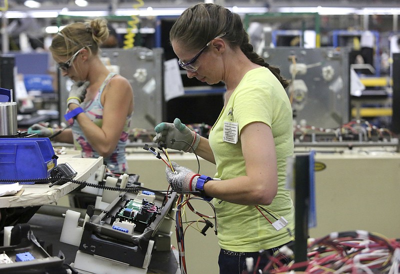 FILE - In this Sept. 20, 2019, file photo, Maurine Carter works on the wiring of a stove in LaFayette, Ga. Orders to American factories for big-ticket goods rebounded last month from a disastrous April as the U.S. economy began to slowly reopen. The Commerce Department said that orders for manufactured goods meant to last at least three years shot up 15.8% in May after plunging 18.1% in April.(Erin O. Smith/Chattanooga Times Free Press via AP, File)