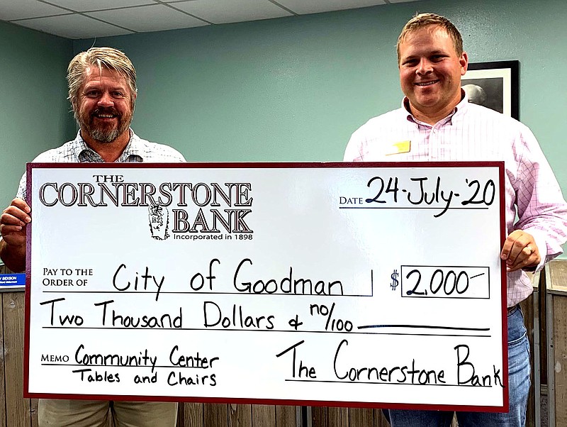 PHOTO SUBMITTED
Mayor J.R. Fisher (left) of Goodman receives a donation of $2,000 for chairs and tables for the new community building from Michael Griffith (right), a representative from The Cornerstone Bank.