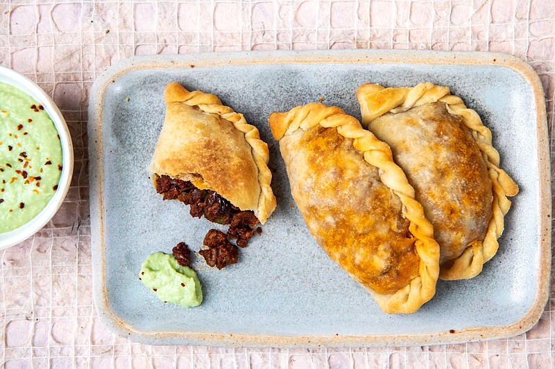 Finely chopped pecans take the place of beef in these Vegan Picadillo Empanadas seasoned with spices, raisins and olives.
(Los Angeles Times/TNS/Mariah Tauger)