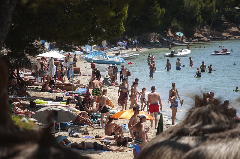 Sunbathers enjoy the beach in Pollença, in the Balearic Island of Mallorca, Spain, Tuesday, July 28, 2020. The U.K. government's recommendation against all but essential travel to the whole of Spain means that all travelers arriving in Britain from that country will have to undergo a 14-day quarantine. (AP Photo/Joan Mateu) story.lead_photo.caption