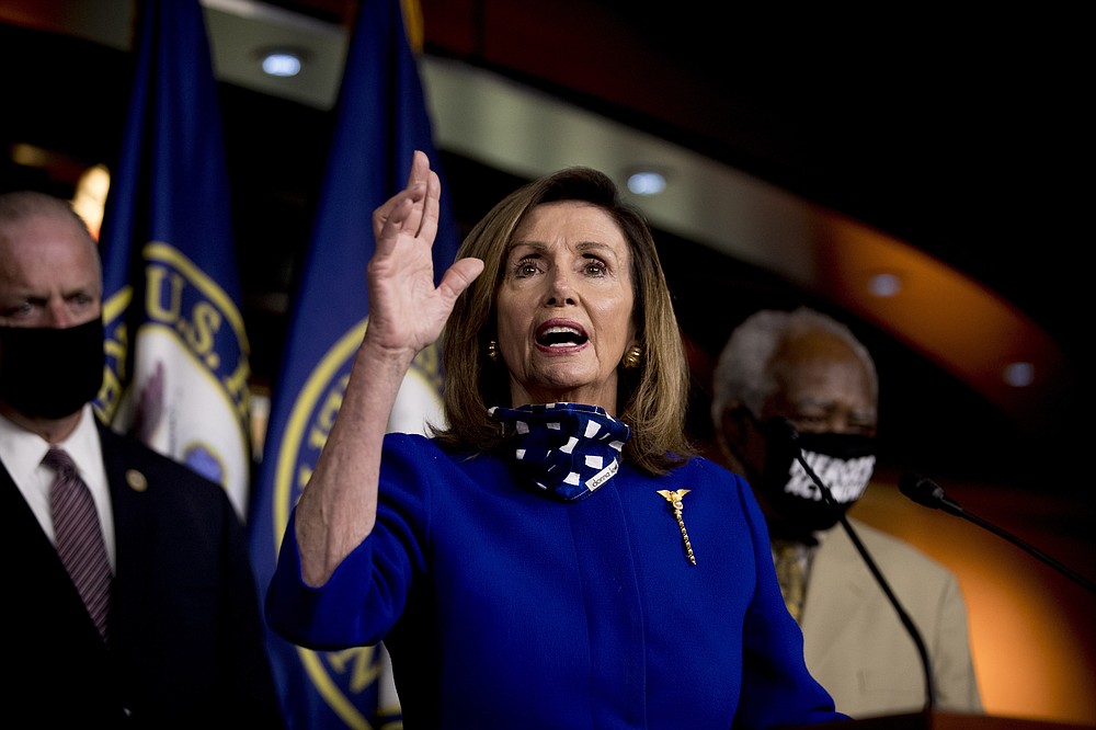 House Speaker Nancy Pelosi of Calif., accompanied by Rep. Dan Kildee, D-Mich., left, and Rep. Danny Davis, D-Ill., right, speaks at a news conference on Capitol Hill in Washington, Friday, July 24, 2020, on the extension of federal unemployment benefits. (AP Photo/Andrew Harnik)