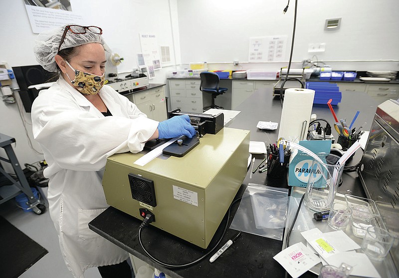 Gabriella Miller, manufacturing team leader, works at NOWDiagnostics in Springdale in June. The company has earned European Union approval for its single-drop test for the covid-19 antibody. (NWA Democrat-Gazette/Andy Shupe) 