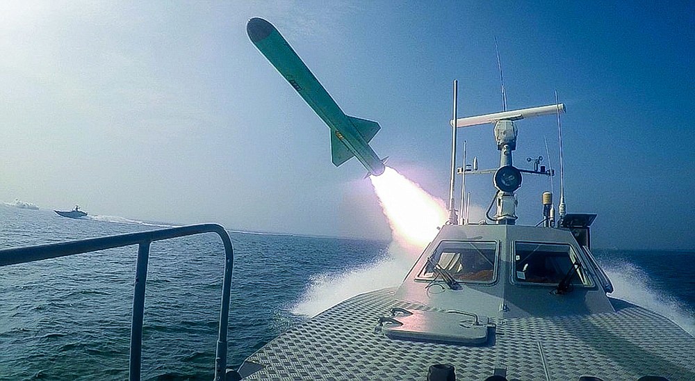 In this photo released Tuesday, July 28, 2020, by Sepahnews, a Revolutionary Guard's speed boat fires a missile during a military exercise. Iranian commandos also fast-roped down from a helicopter onto a replica of an aircraft carrier in the exercise called "Great Prophet 14." The drill appears aimed at threatening the U.S. amid tensions between Tehran and Washington. (Sepahnews via AP)