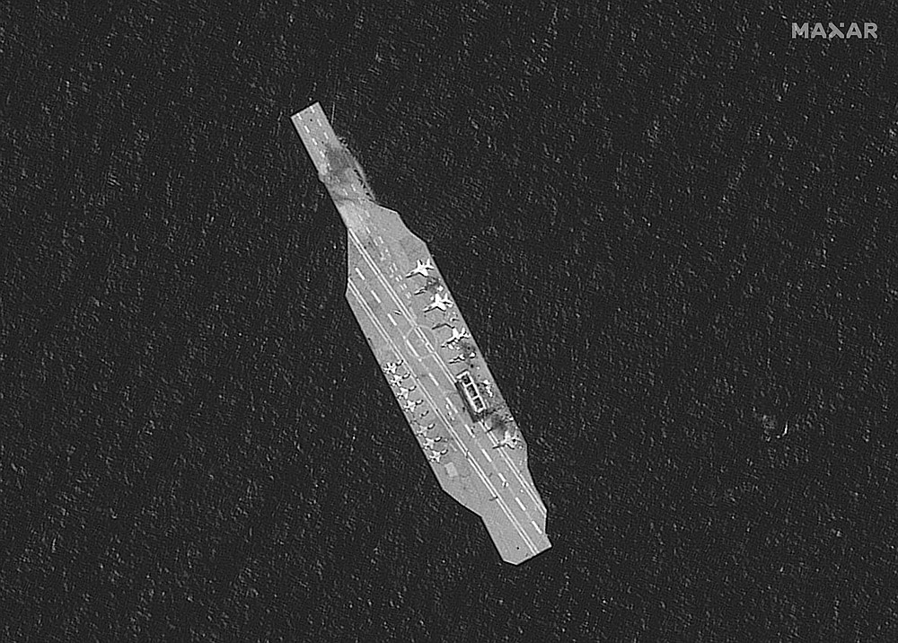 In this Tuesday, July 28, 2020, satellite photo provided by Maxar Technologies, a mockup aircraft carrier built by Iran is seen damaged in the Strait of Hormuz amid a live-fire drill conducted by Iran's Revolutionary Guard. The Guard fired a missile from a helicopter targeting a replica aircraft carrier in the strategic Strait of Hormuz, state television reported on Tuesday, an exercise aimed at threatening the U.S. amid tensions between Tehran and Washington. (Maxar Technologies via AP)