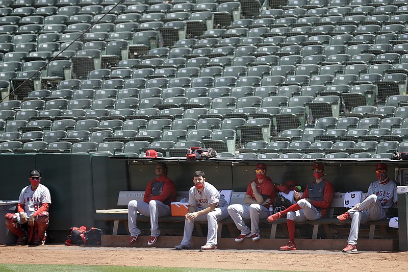 Los Angeles Angels sit in the bullpen during the fifth inning of the team's baseball game against the Oakland Athletics on Monday, July 27, 2020, in Oakland, Calif. (AP Photo/Ben Margot)