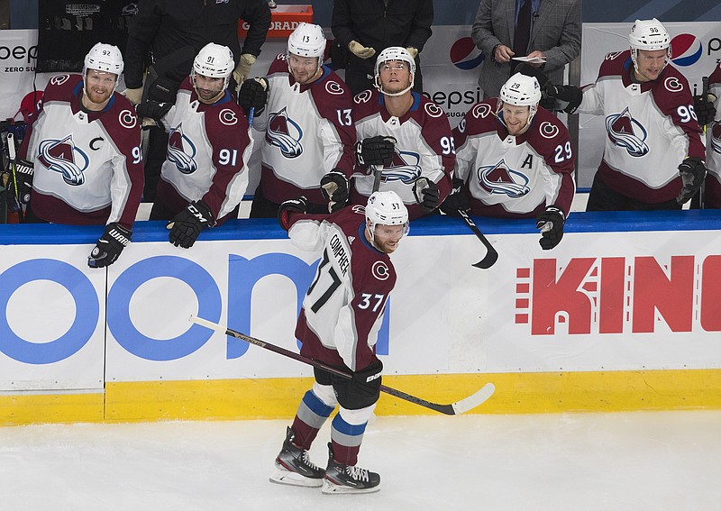 Colorado Avalanche's  J.T. Compher (37) celebrates a goal with teammates during the first period of an exhibition NHL hockey game against the Minnesota Wild  in Edmonton, Alberta, Wednesday, July 29, 2020. (Jason Franson/The Canadian Press via AP)