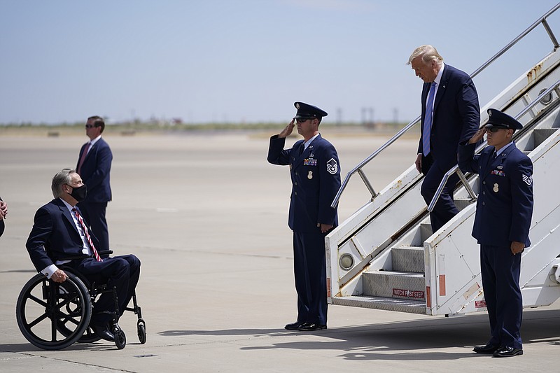 Texas Gov. Greg Abbott waits to greet President Donald Trump as he arrives at Midland International Air and Space Port on Wednesday, July 29, 2020, in Midland, Texas.(AP Photo/Evan Vucci)