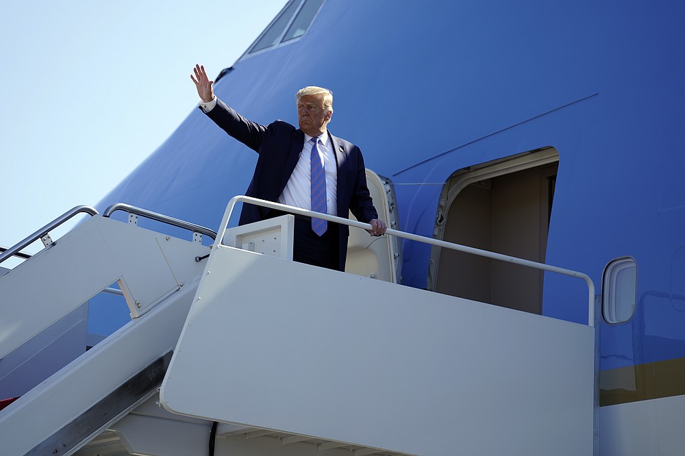 President Donald Trump waves as he boards Air Force One for a trip to Midland, Texas to visit Double Eagle Energy Oil Rig, Wednesday, July 29, 2020, in Andrews Air Force Base, Md. (AP Photo/Evan Vucci)