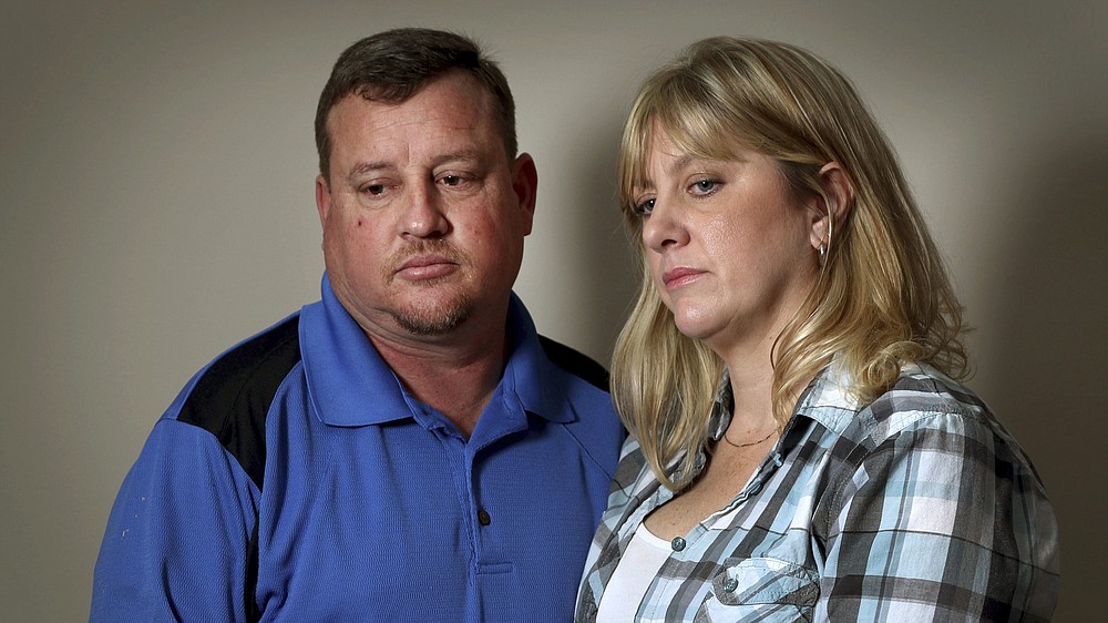 FILE- In this Feb. 17, 2018 photo, Kimberly and James Snead recount the day of the shooting at Marjory Stonemason Douglas High School in Parkland, Fla., where 17 people were killed in a mass shooting. The Snead's, who had taken suspected gunman Nikolas Cruz in their home after his mother died, told the Sun-Sentinel newspaper they had no idea the extent of Cruz's issues. In a letter released Tuesday, July 28, 2020, that is part of a legal agreement to settle numerous civil lawsuits, the Snead's said they were wrong in allowing Cruz to store his firearms in their home, including the AR-15 used in the mass shooting. (Susan Stocker/South Florida Sun-Sentinel via AP, File)