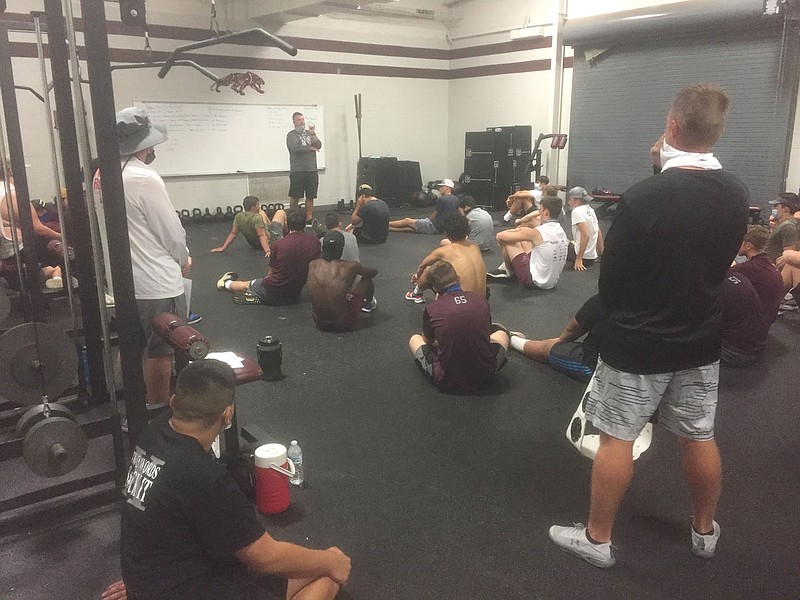 Graham Thomas/Siloam Sunday
Members of the Siloam Springs football team listen as coach Brandon Craig gives instructions at the end of practice Thursday morning inside the Panther Fieldhouse.