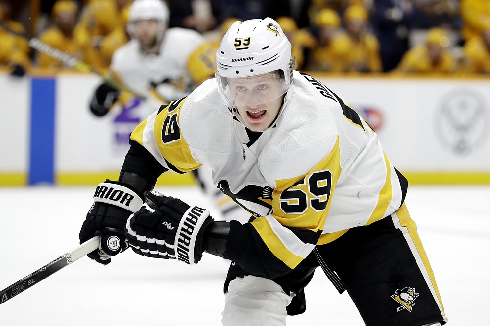 FILE -In this Dec. 28, 2019, file photo, Pittsburgh Penguins left wing Jake Guentzel skates against the Nashville Predators during an NHL hockey game in Nashville, Tenn. Columbus defenseman Seth Jones, Pittsburgh forward Jake Guentzel and Tampa Bay captain Steven Stamkos would’ve missed some or all of the playoffs if they started in April. Instead, the silver lining of the COVID-19 pandemic halting the season is those players are healthy and ready to contribute. (AP Photo/Mark Humphrey,File)