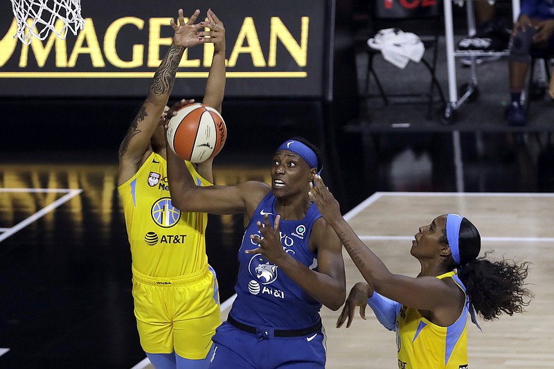 Minnesota Lynx center Sylvia Fowles (34) is double teamed by Chicago Sky forward Gabby Williams (15) and forward Azura Stevens (30) as she goes to the basket during the first half of Thursday's WNBA game in Bradenton, Fla. - Photo by Chris O'Meara of The Associated Press story.lead_photo.caption