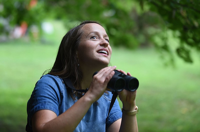 Meredith Bergstrom looks Thursday, July 9, 2020, for an Indigo Bunting in her backyard of her Siloam Springs home. With the pandemic Bergstrom has had the opportunity to spend more time pursuing her bird watching hobby. Check out nwaonline.com/200723Daily/ and nwadg.com/photos for a photo gallery.
(NWA Democrat-Gazette/David Gottschalk)