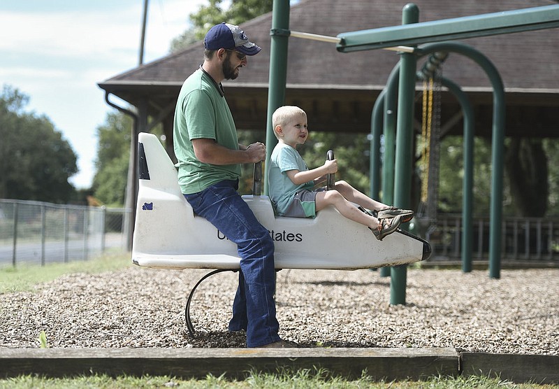 Jonathan Hutchins (from left) and Matthew Hutchins, 4, play, Saturday, August 1, 2020 at a park on Sunrise Dr. in Bethel Heights. Voters in Springdale and Bethel Heights will determine August 11 if Springdale will annex its neighbor to the north. Check out nwaonline.com/200802Daily/ for today's photo gallery. 
(NWA Democrat-Gazette/Charlie Kaijo)
