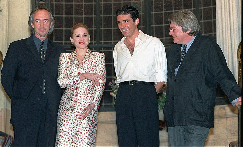 FILE - British actor Jonathan Pryce, from left, American actress-singer Madonna and Spanish actor Antonio Banderas appear at e news conference about the musical film "Evita" with British director Alan Parker in Buenos Aires on Feb. 6, 1996. Parker, whose movies included “Bugsy Malone,” “Midnight Express” and “Evita,” has died at the age of 76. A statement from the director’s family says Parker died Friday in London after a long illness. (AP Photo/Daniel Muzio, File)