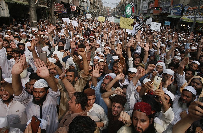 Supporters of a religious group chant slogans during a rally favoring the Khalid Khan, who gunned down Tahir Naseem in courtroom, in Peshawar, Pakistan, Friday, July 31, 2020. Naseem, a U.S. citizen, according to a U.S. State Department statement, was gunned down this week in a Pakistani courtroom while standing trial on a charge of blasphemy. (AP Photo/Muhammad Sajjad)