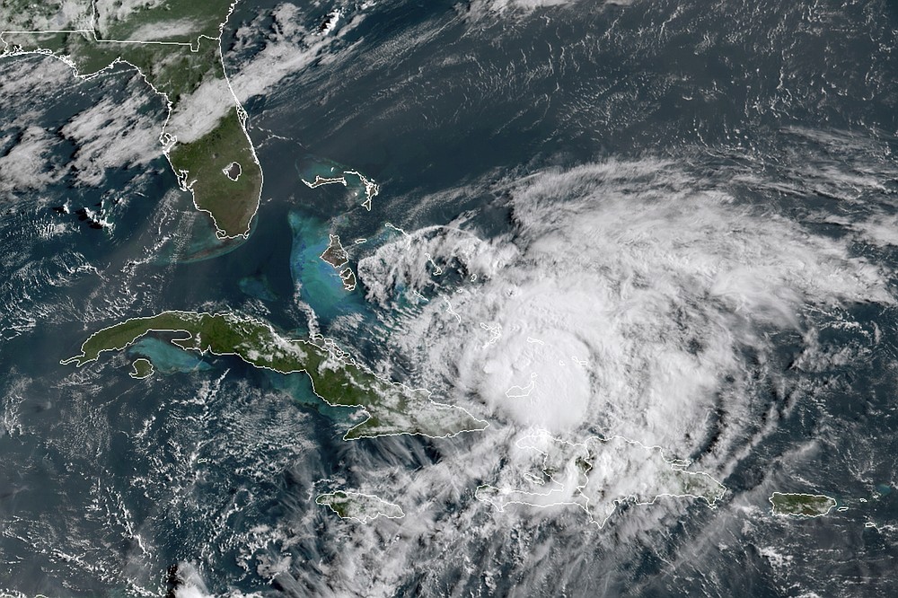 In this GOES-16 satellite image taken Friday, July 31, 2020, at 8:40 a.m. EDT., and provided by NOAA, Hurricane Isaias churns in the Caribbean. Hurricane Isaias kept on a path early Friday toward the U.S. East Coast as it approached the Bahamas, parts of which are still recovering from the devastation of last year's Hurricane Dorian. (NOAA via AP)