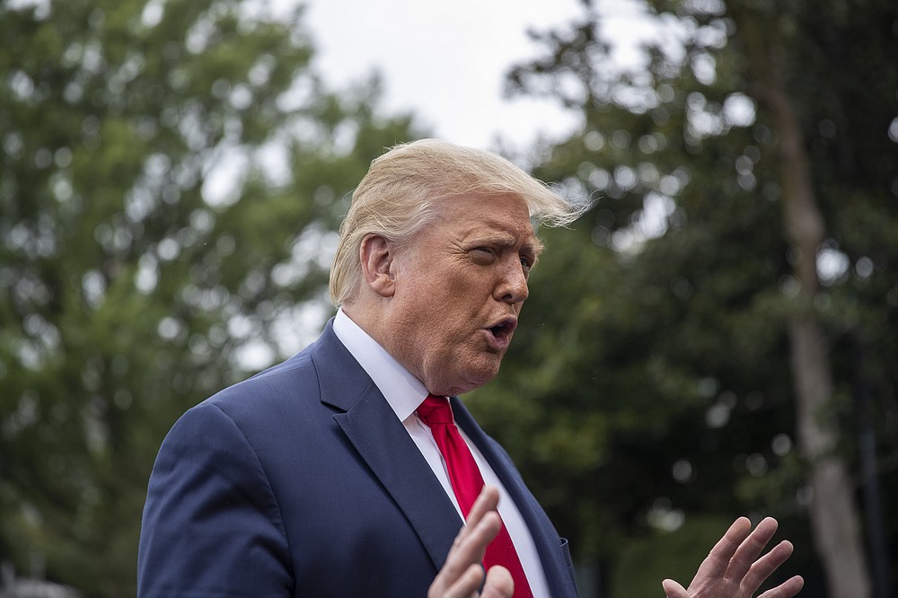President Donald Trump speaks with reporters as he walks to Marine One on the South Lawn of the White House, Friday, July 31, 2020, in Washington. Trump is en route to Florida. (AP Photo/Alex Brandon)