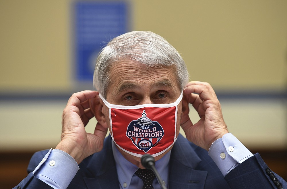 Dr. Anthony Fauci, director of the National Institute for Allergy and Infectious Diseases, adjusts his face mask during a House Subcommittee on the Coronavirus crisis hearing, Friday, July 31, 2020 on Capitol Hill in Washington. (Kevin Dietsch/Pool via AP)