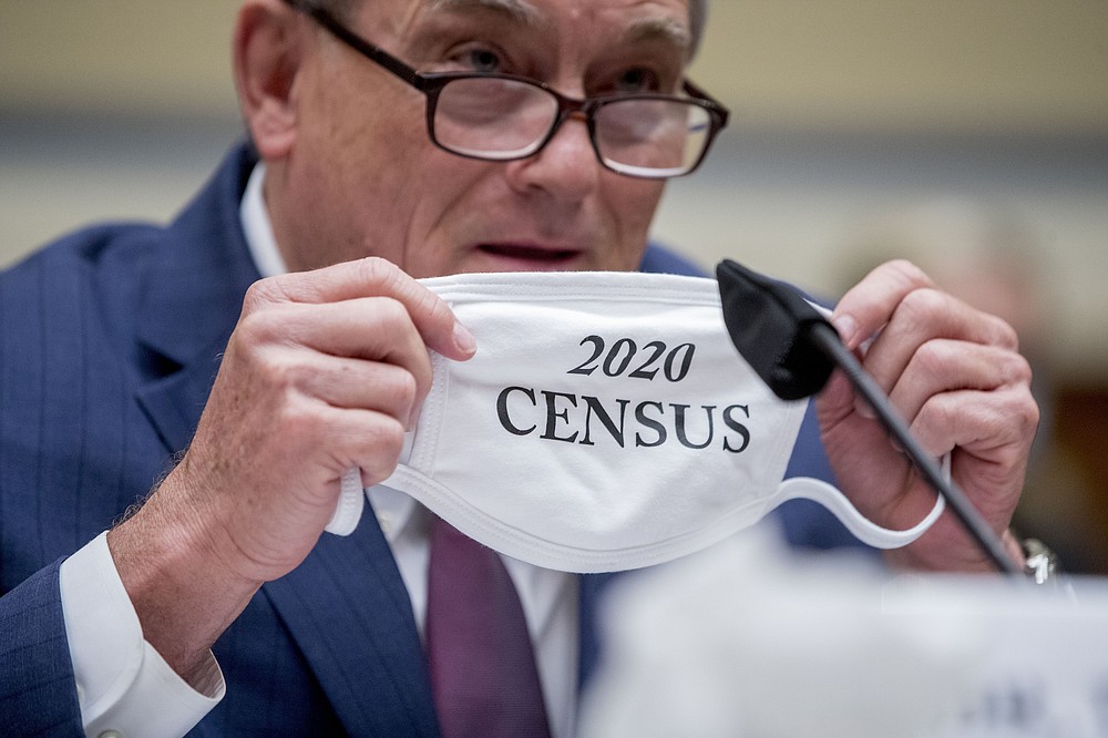 Census Bureau Director Steven Dillingham holds up his mask with the words "2020 Census" as he testifies before a House Committee on Oversight and Reform hearing on the 2020 Census on Capitol Hill, Wednesday, July 29, 2020, in Washington. (AP Photo/Andrew Harnik)