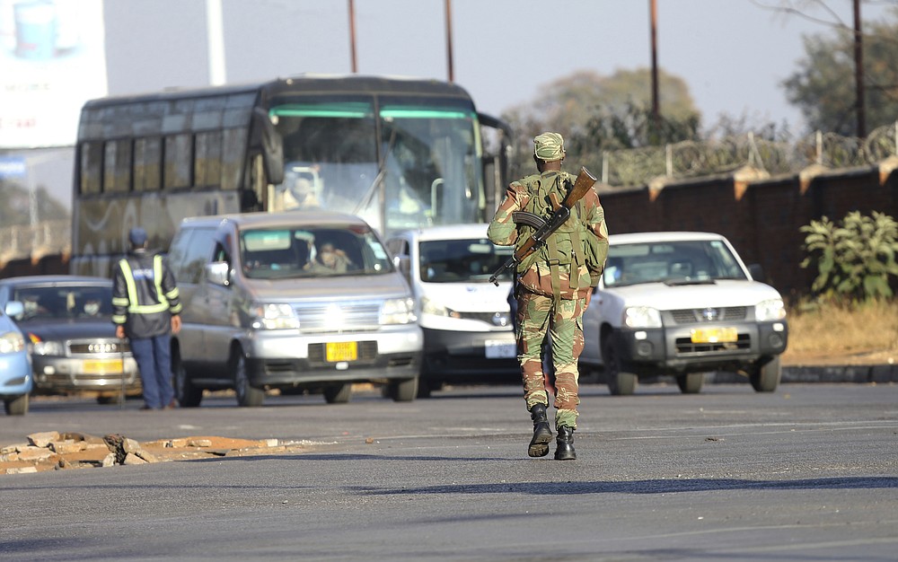 An armed soldier is seen on a street in Harare, Friday, July, 31, 2020. Zimbabwe's capital, Harare, was deserted Friday, as security agents vigorously enforced the country's lockdown amidst planned protests. Police and soldiers manned checkpoints and ordered people seeking to get into the city for work and other chores to return home. (AP Photo/Tsvangirayi Mukwazhi)