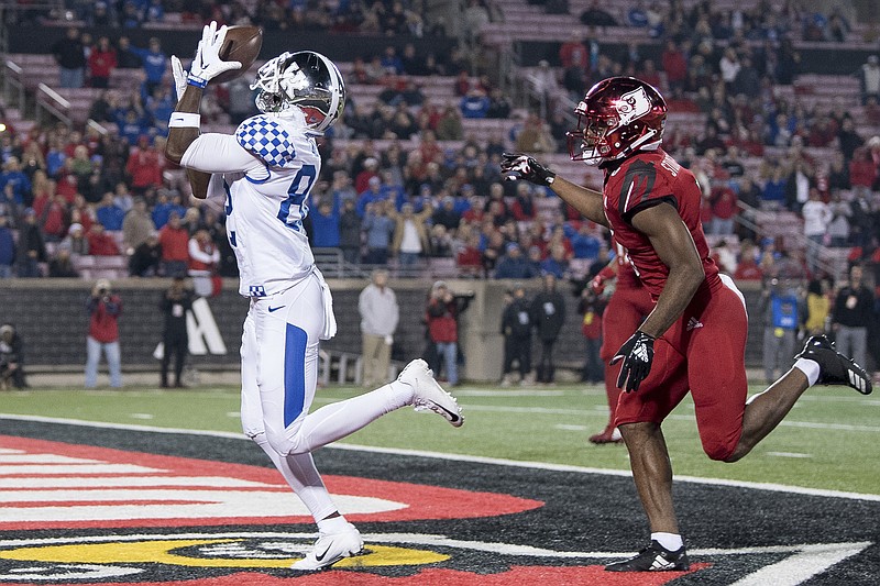 Kentucky wide receiver Josh Ali (82) catches a touchdown pass during the team's Nov. 24, 2018, NCAA game against Louisville in Louisville, Ky. The Southeastern Conference's conference-only scheduling decision during the coronavirus pandemic wiped out any hopes of saving four in-state rivalries against Atlantic Coast Conference opponents, all traditionally played on the final Saturday of the regular season. - Photo by Bryan Woolston of The Associated Press story.lead_photo.caption