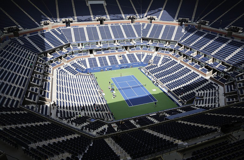 Players practice for the U.S. Open tennis tournament at Arthur Ashe Stadium in New York on Aug. 27, 2017. As coronavirus cases spike in other parts of the country a month before the U.S. Open is supposed to start in New York, the U.S. Tennis Association said Friday it “continues its plans” to hold its marquee event and another tournament beforehand. - Photo by Peter Morgan of The Associated Press