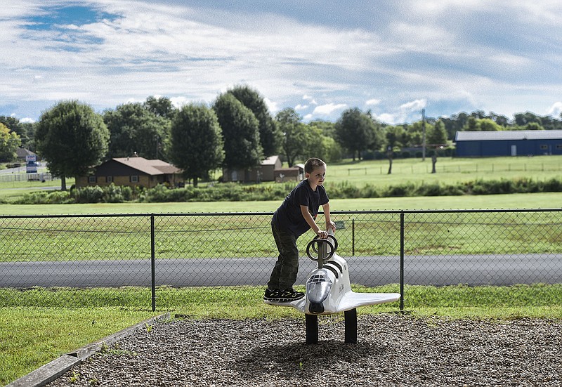 Noah Purser of Farmington plays on a space shuttle, Saturday, August 1, 2020 at a park on Sunrise Dr. in Bethel Heights. Voters in Springdale and Bethel Heights will determine August 11 if Springdale will annex its neighbor to the north. (NWA Democrat-Gazette/Charlie Kaijo)