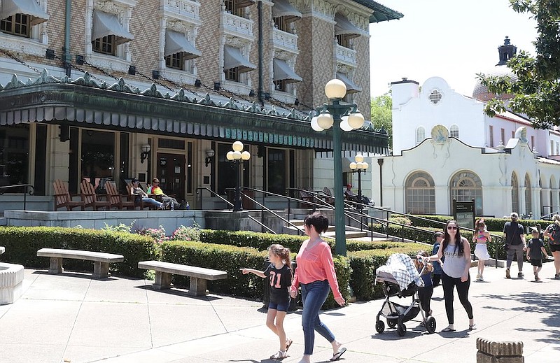 Hot Springs National Park visitors stroll down Bathhouse Row in April.  - File photo by Richard Rasmussen of The Sentinel-Record