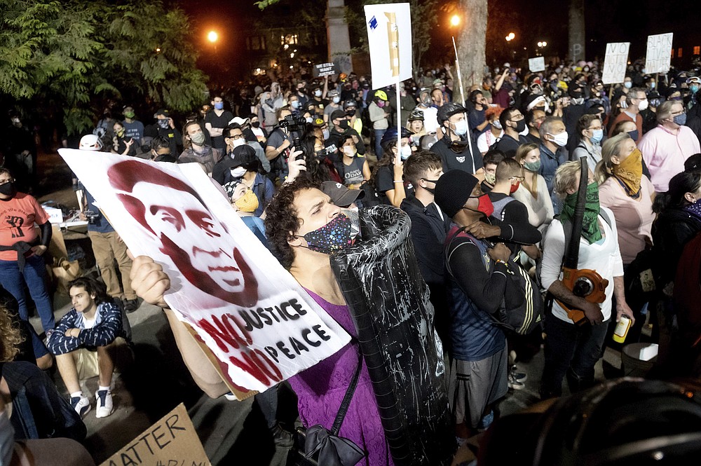 Black Lives Matter protesters rally at the Mark O. Hatfield United States Courthouse on Friday, July 31, 2020, in Portland, Ore. Following an agreement between Democratic Gov. Kate Brown and the Trump administration to reduce federal officers in the city, nightly protests remained largely peaceful without major confrontations between demonstrators and officers. (AP Photo/Noah Berger)