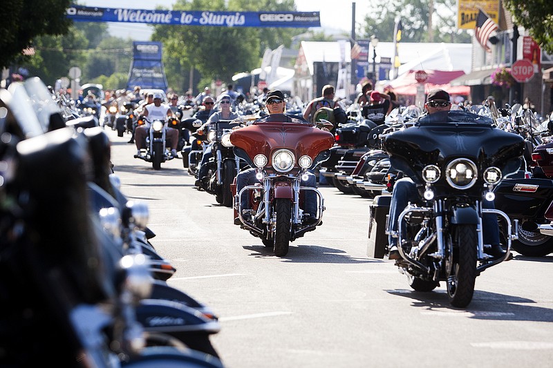 FILE - In this Aug. 5, 2016 file photo, bikers ride down Main Street in downtown Sturgis, S.D., before the 76th Sturgis motorcycle rally officially begins.  South Dakota, which has seen an uptick in coronavirus infections in recent weeks, is bracing to host hundreds of thousands of bikers for the 80th edition of the Sturgis Motorcycle Rally. Over a quarter of a million people are expected to rumble through western South Dakota. (Josh Morgan/Rapid City Journal via AP, File)