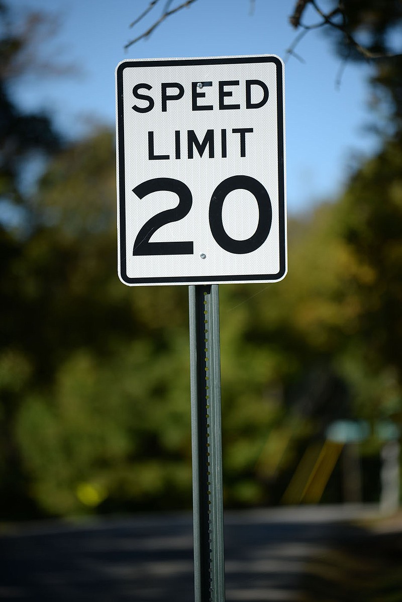 A 20-mph sign stands Oct. 17 along Prospect Street north of Wilson Park in Fayetteville. The city installed 20-mph speed limit signs on residential streets near Wilson Park as a pilot program to test lower speed limits in neighborhoods with bike routes. (File photo/NWA Democrat-Gazette/Andy Shupe)