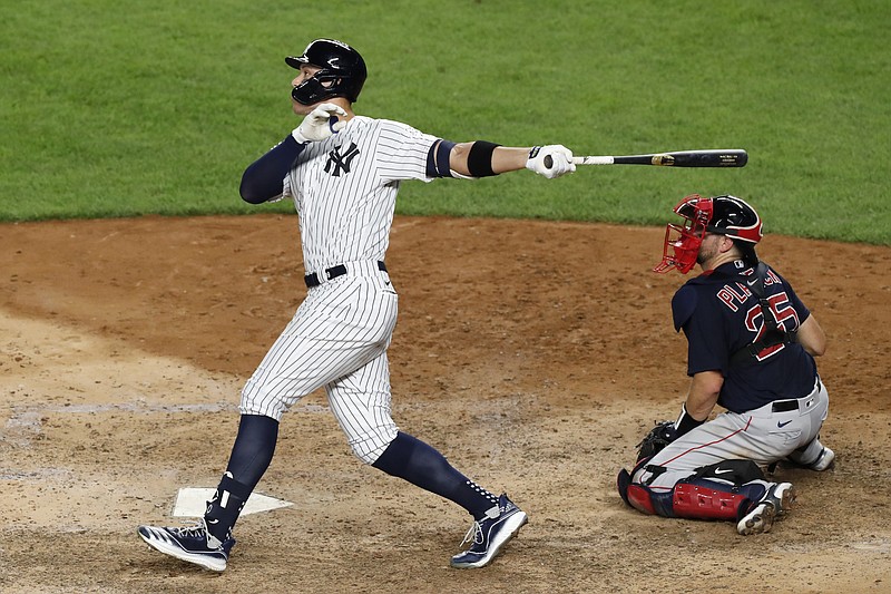 New York Yankees' Aaron Judge follows through on an eighth-inning, two-run home run against the Boston Red Sox in Sunday's game at Yankee Stadium in New York. Red Sox catcher Kevin Plawecki is at right. - Photo by Kathy Willens of The Associated Press
