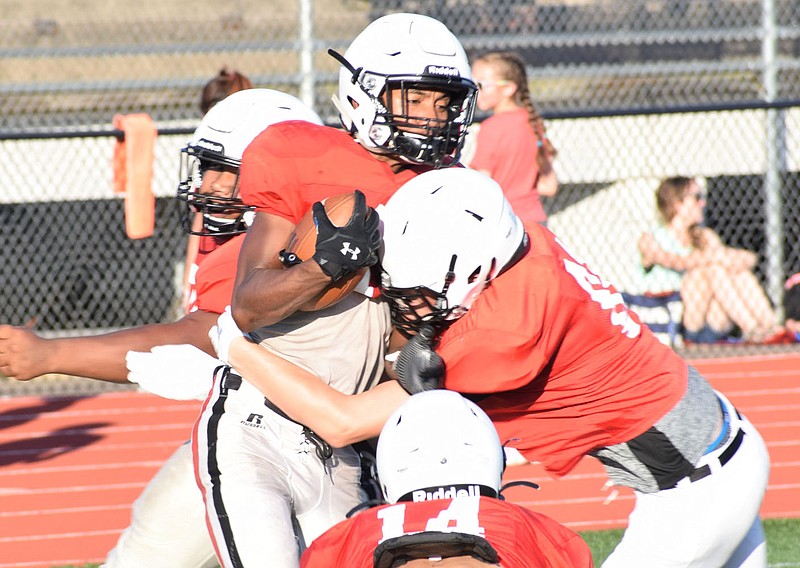 RICK PECK/SPECIAL TO MCDONALD COUNTY PRESS Trent Alik fights for extra yards after catching a pass during a July 30 scrimmage at the McDonald County High School football team's final day of a two-week camp.