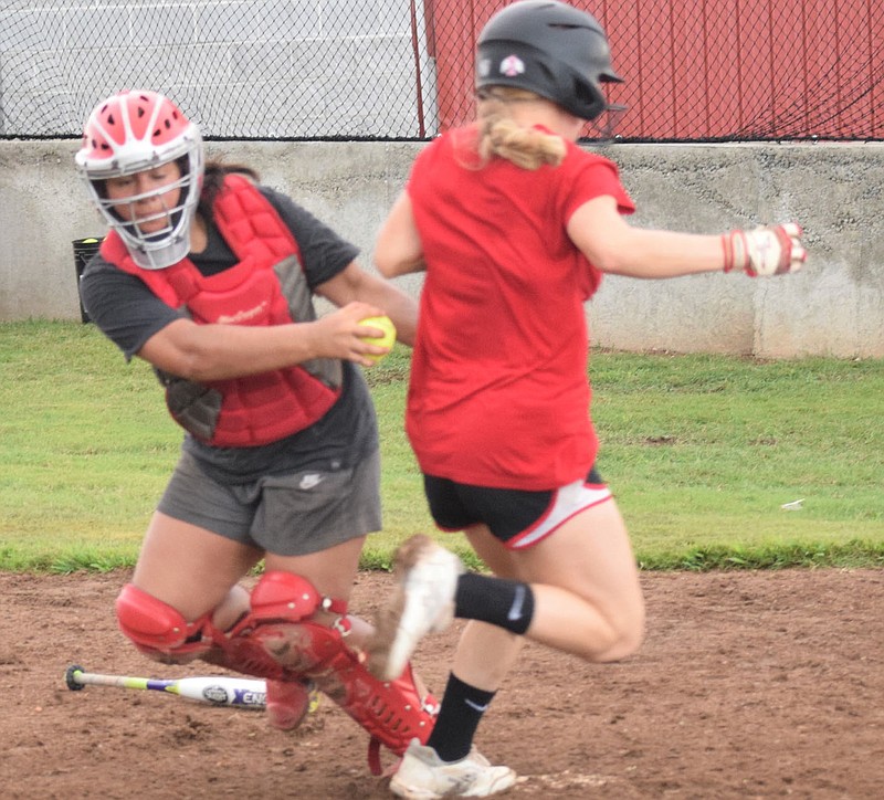RICK PECK/SPECIAL TO MCDONALD COUNTY PRESS Reagan Myrick beats a tag by catcher Mariana Salas during the McDonald County High School softball team's scrimmage on July 30 during the Lady Mustangs camp.