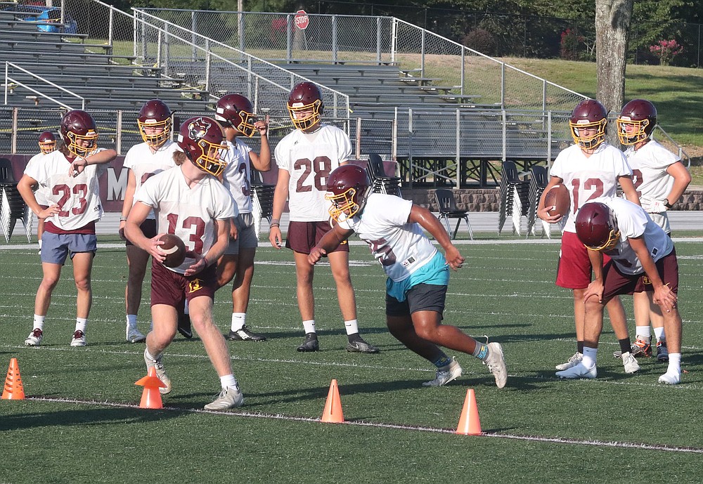 Football players at Lake Hamilton run through agility drills during practice at Wolf Stadium. - Photo by Richard Rasmussen of The Sentinel-Record