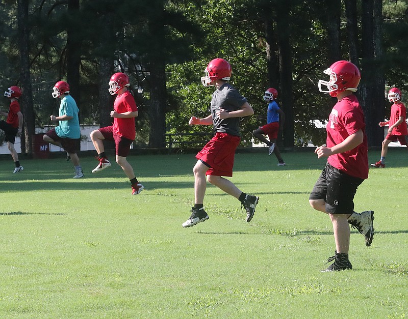 Football players go through drills during the first official practice of the season at Mountain Pine. - Photo by Richard Rasmussen of The Sentinel-Record