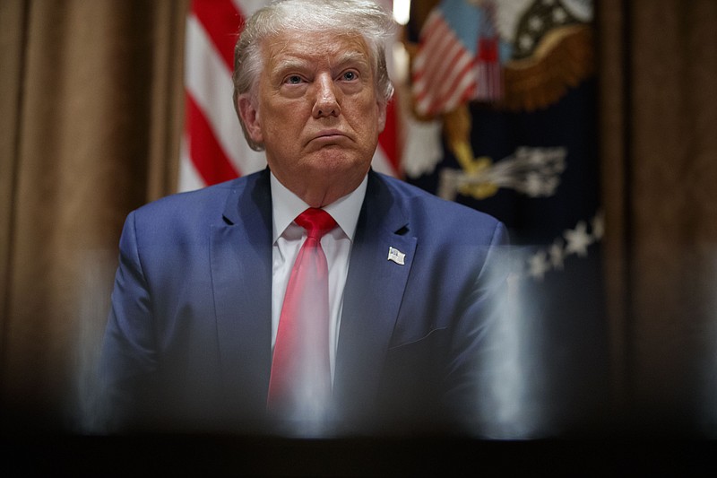President Donald Trump listens during a meeting with U.S. tech workers, before signing an Executive Order on hiring American workers, in the Cabinet Room of the White House, Monday, Aug. 3, 2020, in Washington. A Manhattan prosecutor trying to get President Trump’s tax returns told a judge Monday that he was justified in demanding them, citing public reports of “extensive and protracted criminal conduct at the Trump Organization.” Trump’s lawyers last month said the grand jury subpoena for the tax returns was issued in bad faith and amounted to harassment of the president. (AP Photo/Alex Brandon)