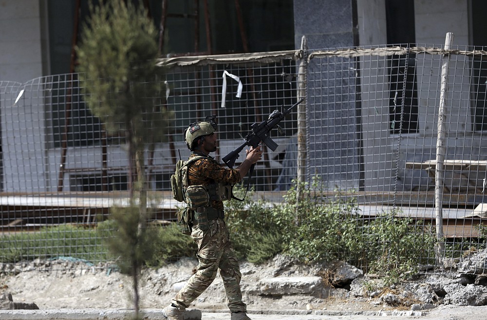 An Afghan security personnel takes position in front of a prison after an attack in the city of Jalalabad, east of Kabul, Afghanistan, Monday, Aug. 3, 2020. An Islamic State group attack on the prison in eastern Afghanistan holding hundreds of its members raged on Monday after killing people in fighting overnight, a local official said. (AP Photo/Rahmat Gul)