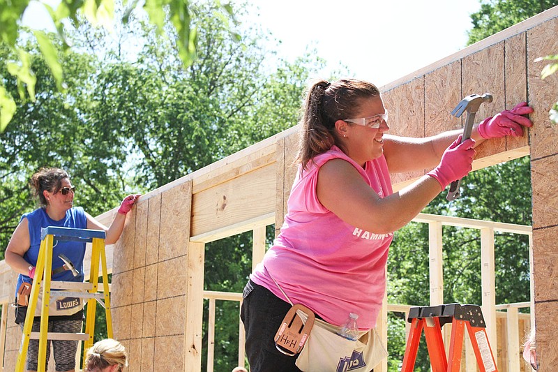 A Heels to Hammers crew works on a Habitat for Humanity house on  Garland Avenue in 2018. - File photo by The Sentinel-Record