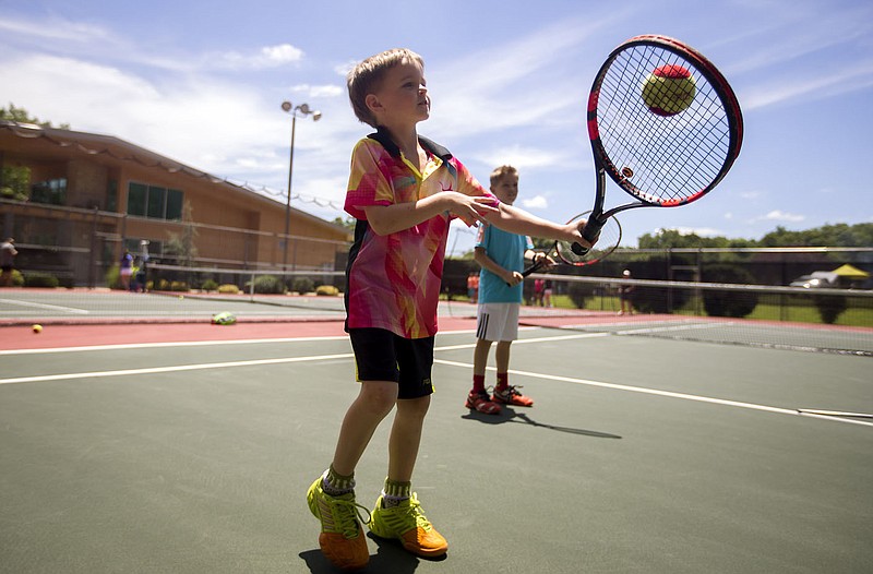 NWA Democrat-Gazette/JASON IVESTER
Alex Piech , 7, and his brother Jason Piech, 10, both of Rogers, work on their returns Thursday, June 8, 2017, at the Kingsdale Tennis Complex in Bella Vista. The boys and other youth were participating in the annual Cancer Challenge Junior Tennis Clinic and Tournament.