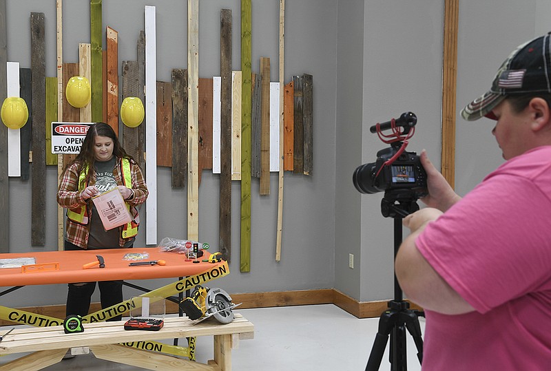 Alisa Staton, left, Vacation Bible School director for Hot Springs Baptist Church, 144 Weston Road, and Toni Hubbard set up to film craft time for the church’s virtual vacation bible school on Thursday at the church. - Photo by Grace Brown of The Sentinel-Record