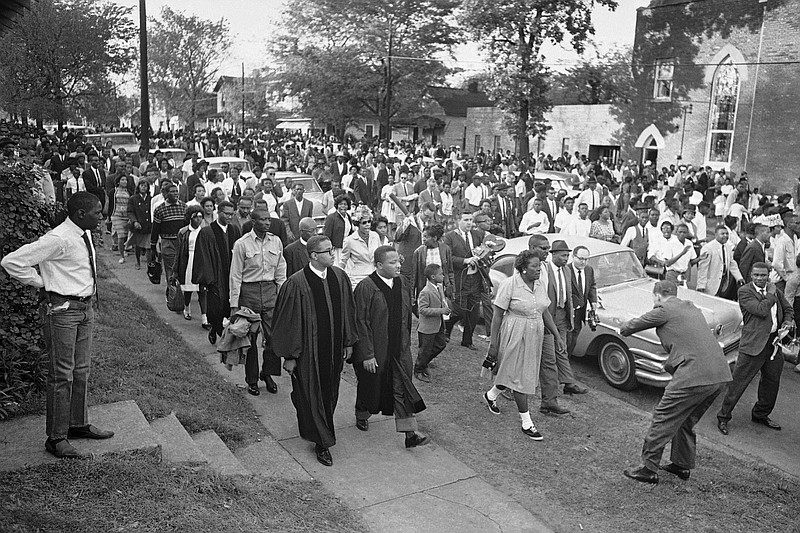 FILE - In this April 14, 1963 file photo, two ministers lead protest marchers in a civil rights demonstration in Birmingham, Ala., which was later broken up by police. The U.S. civil rights movement of the 1950s and 1960s achieved monumental changes over a 15-year period, including landmark federal laws. Yet racism and discrimination remain pervasive problems in 2020. (AP Photo/Horace Cort)