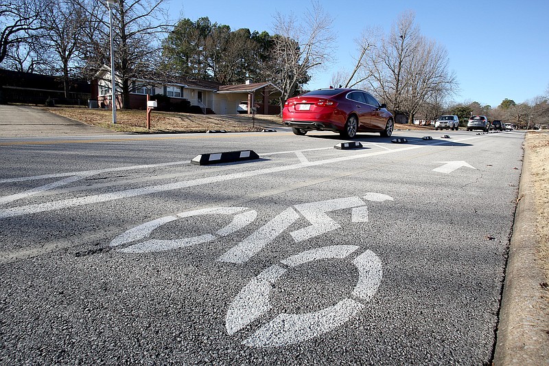 NWA Democrat-Gazette/DAVID GOTTSCHALK  The temporary bike lanes are visible on Rolling Hills Drive Wednesday, January 9, 2019, as traffic passes by in Fayetteville. BikeNWA, a regional bicycling advocacy organization, installed the temporary protected bike lanes at Rolling Hills Drive in November as part of a larger pilot project including Springdale and Eureka Springs paid for through a grant from the Walton Family Foundation.